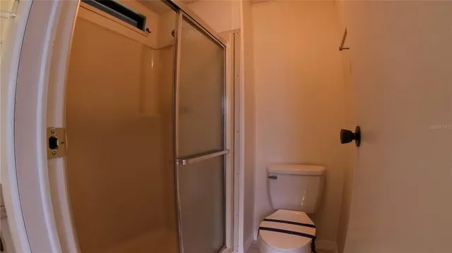 a bathroom with a shower and a toilet