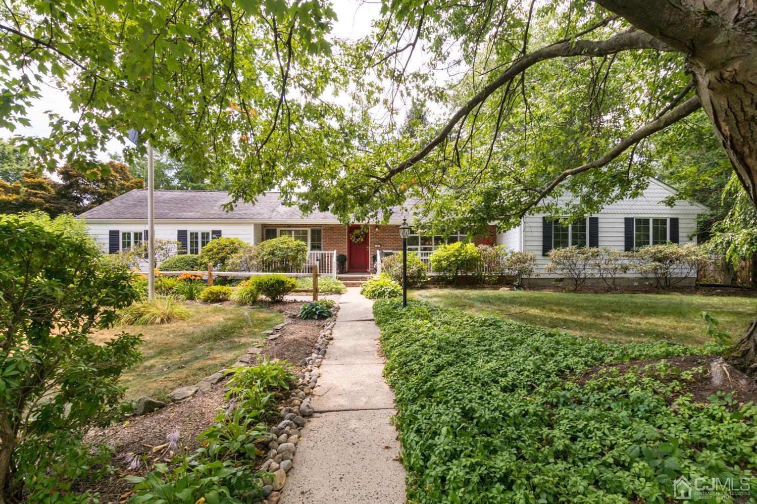 1 Holmes Road Cranbury, NJ 08512 - Photo 1 of 39 a front view of a house with a yard table and chairs