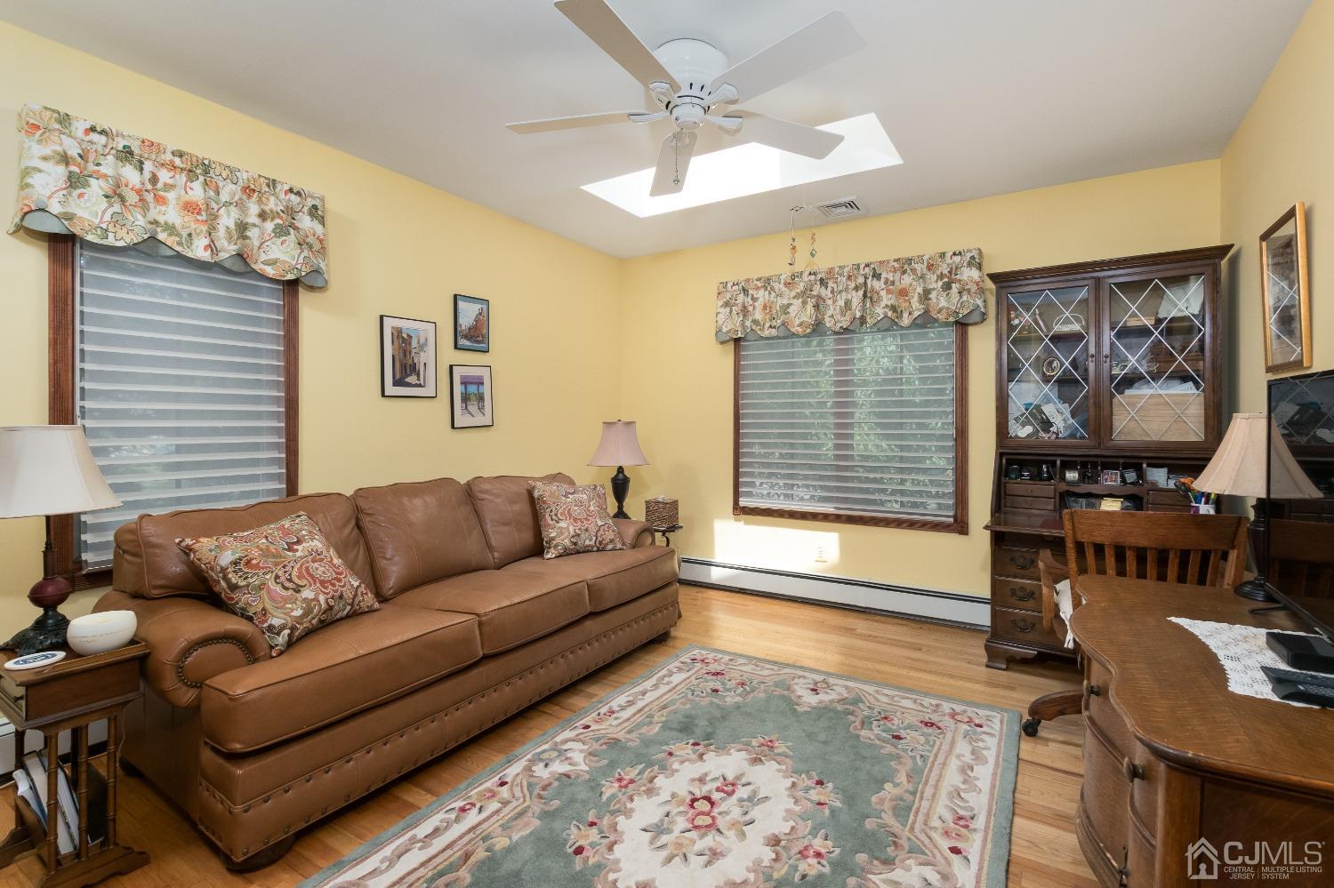 1 Holmes Road Cranbury, NJ 08512 - Photo 23 of 39 a living room with furniture and a flat screen tv