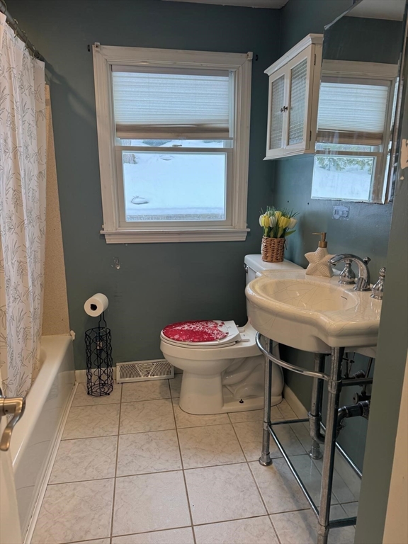 22 Falcon Street Methuen, MA 01844 - Photo 8 of 12 a bathroom with a sink a toilet and a window