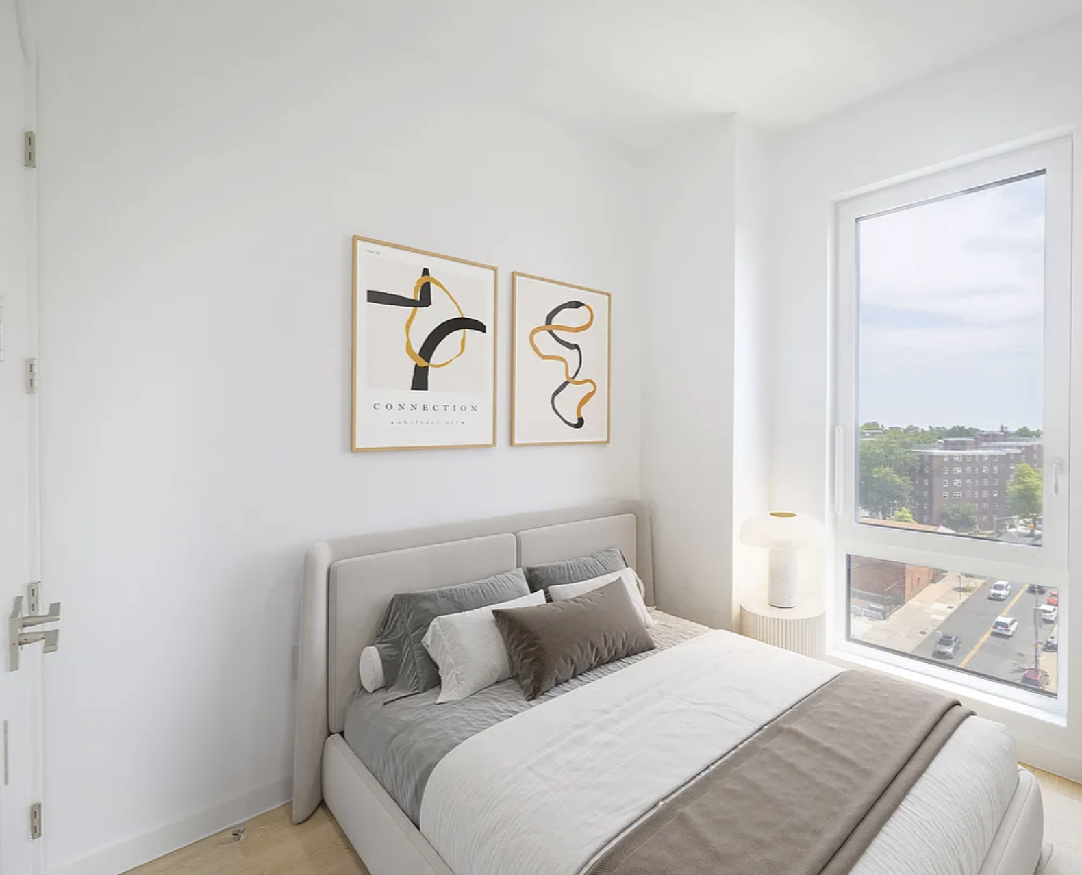 1889 Atlantic Avenue, Unit 9E Brooklyn, NY 11233 - Photo 5 of 9 a bedroom with a bed and a large window with outer view