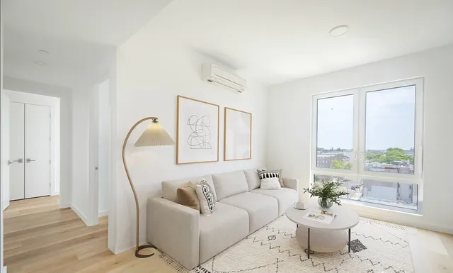 a bedroom with a bed and a large window with outer view