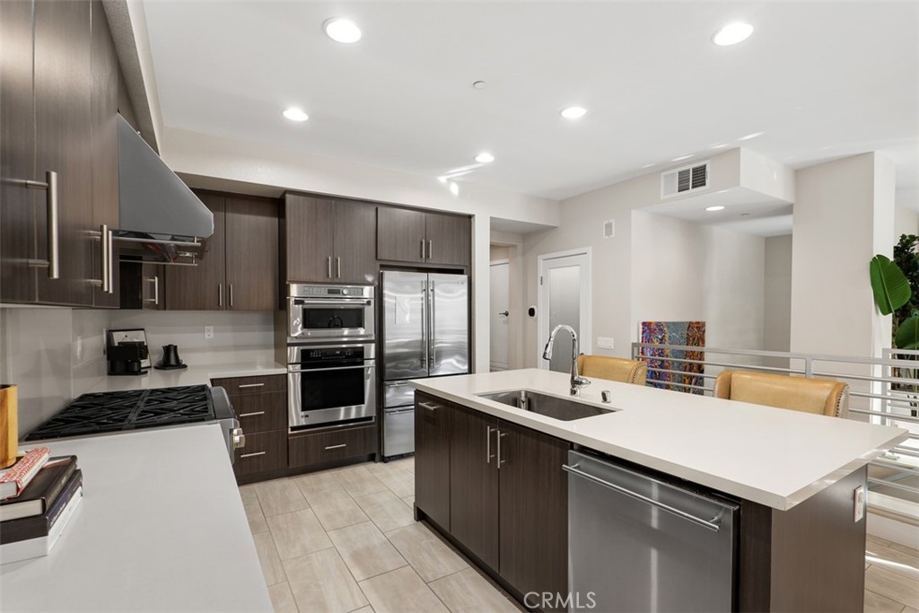 612 Rockefeller Irvine, CA 92612 - Photo 3 of 12 a kitchen with stainless steel appliances a stove sink and refrigerator