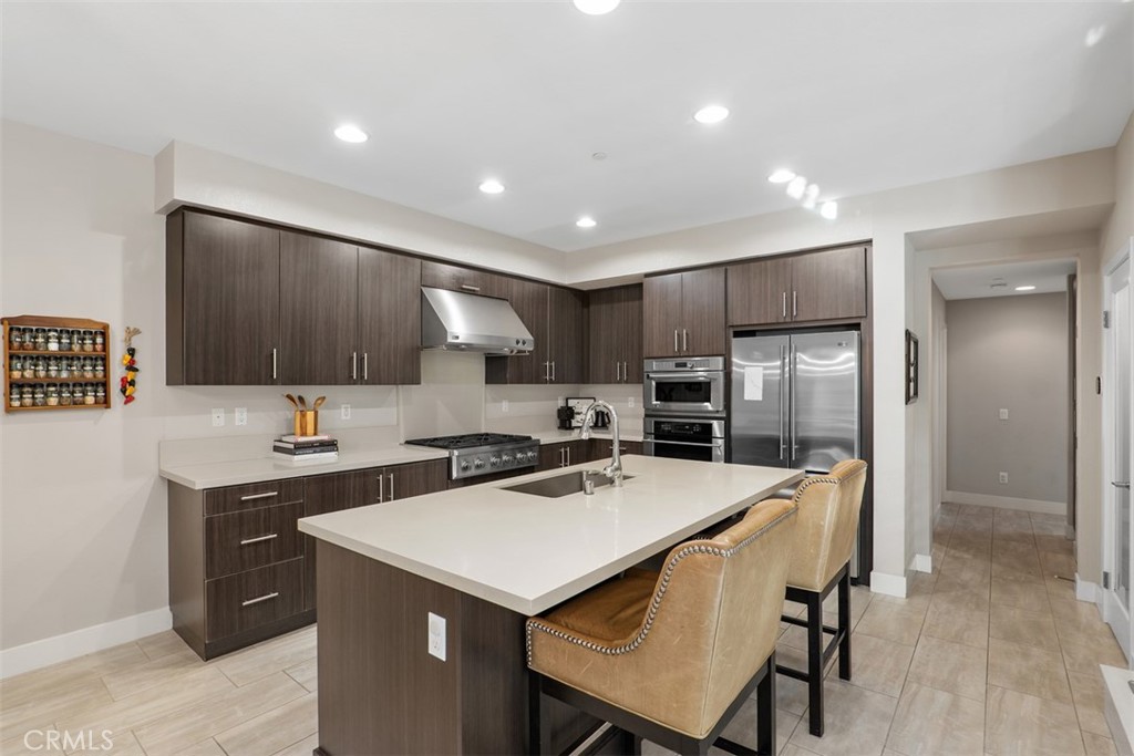 612 Rockefeller Irvine, CA 92612 - Photo 4 of 12 a kitchen with a refrigerator a sink and a stove