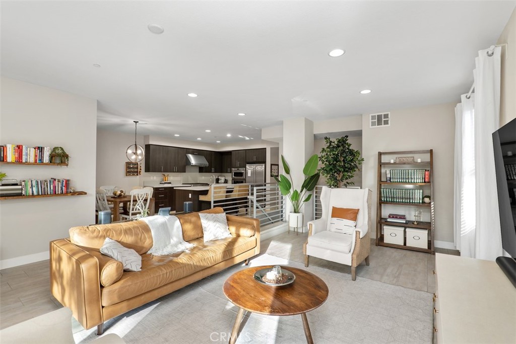 612 Rockefeller Irvine, CA 92612 - Photo 7 of 12 a living room with furniture kitchen view and a large window