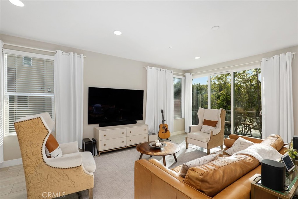612 Rockefeller Irvine, CA 92612 - Photo 8 of 12 a living room with furniture and a flat screen tv