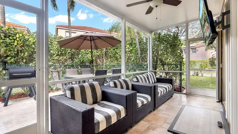 a balcony with furniture and umbrella