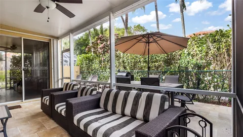 a view of a patio with couches under an umbrella