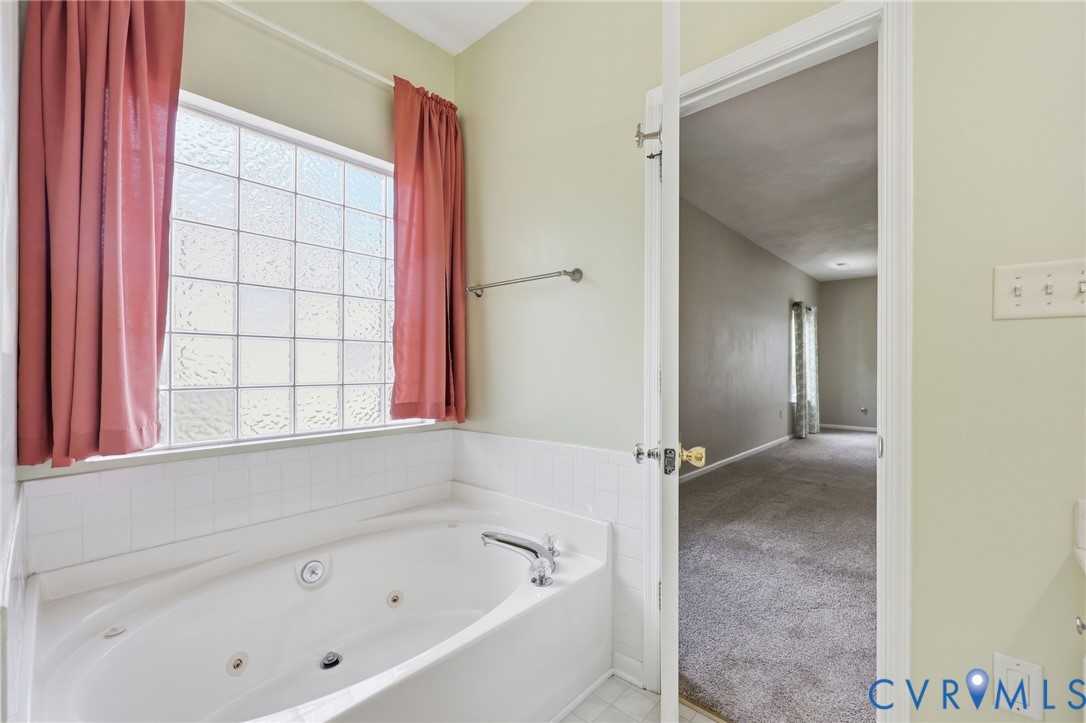 14719 Clover Ridge Lane Chesterfield, VA 23832 - Photo 19 of 36 Soaking tub with integrated jets, white tile surro