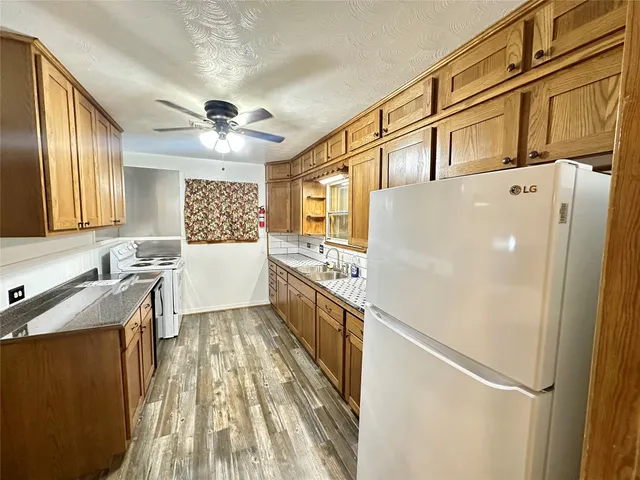 a white refrigerator freezer sitting inside of a kitchen