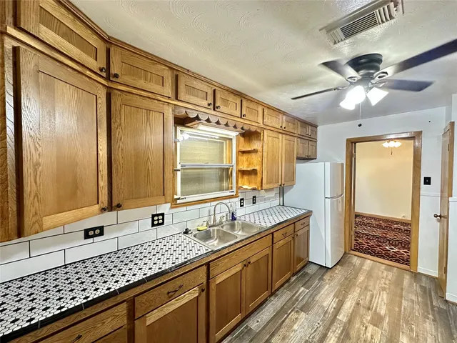 a bathroom with a double vanity sink mirror and shower