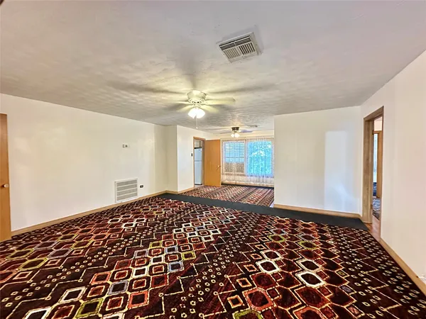 a view of a bedroom with wooden floor