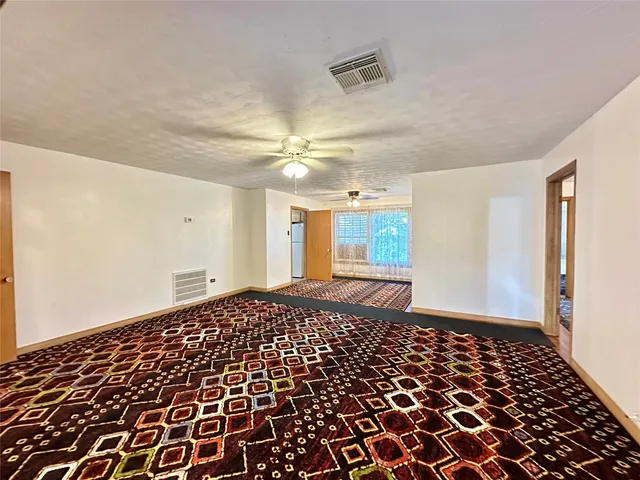 a view of a bedroom with wooden floor