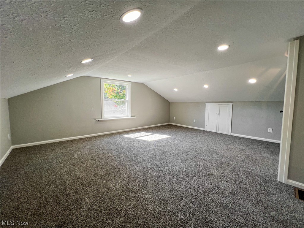 602 West Marshall Road McDonald, OH 44437 - Photo 11 of 19 Upstairs bedroom with dark colored carpet, and lofted ceiling
