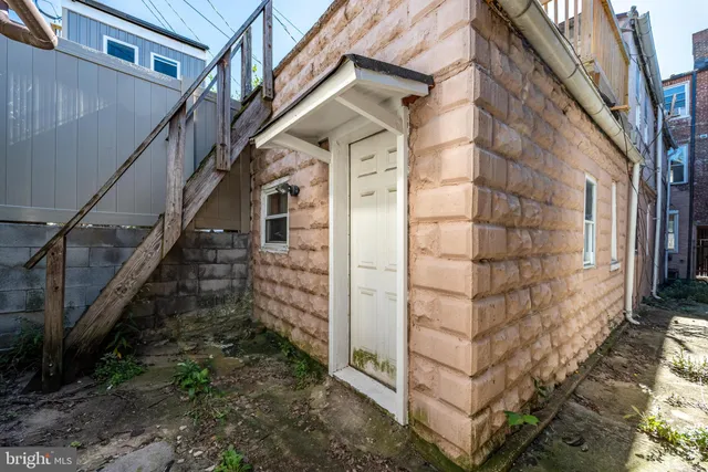 a view of wooden staircase with a white door