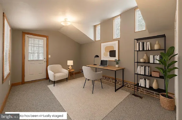 a living room with furniture and a book shelf