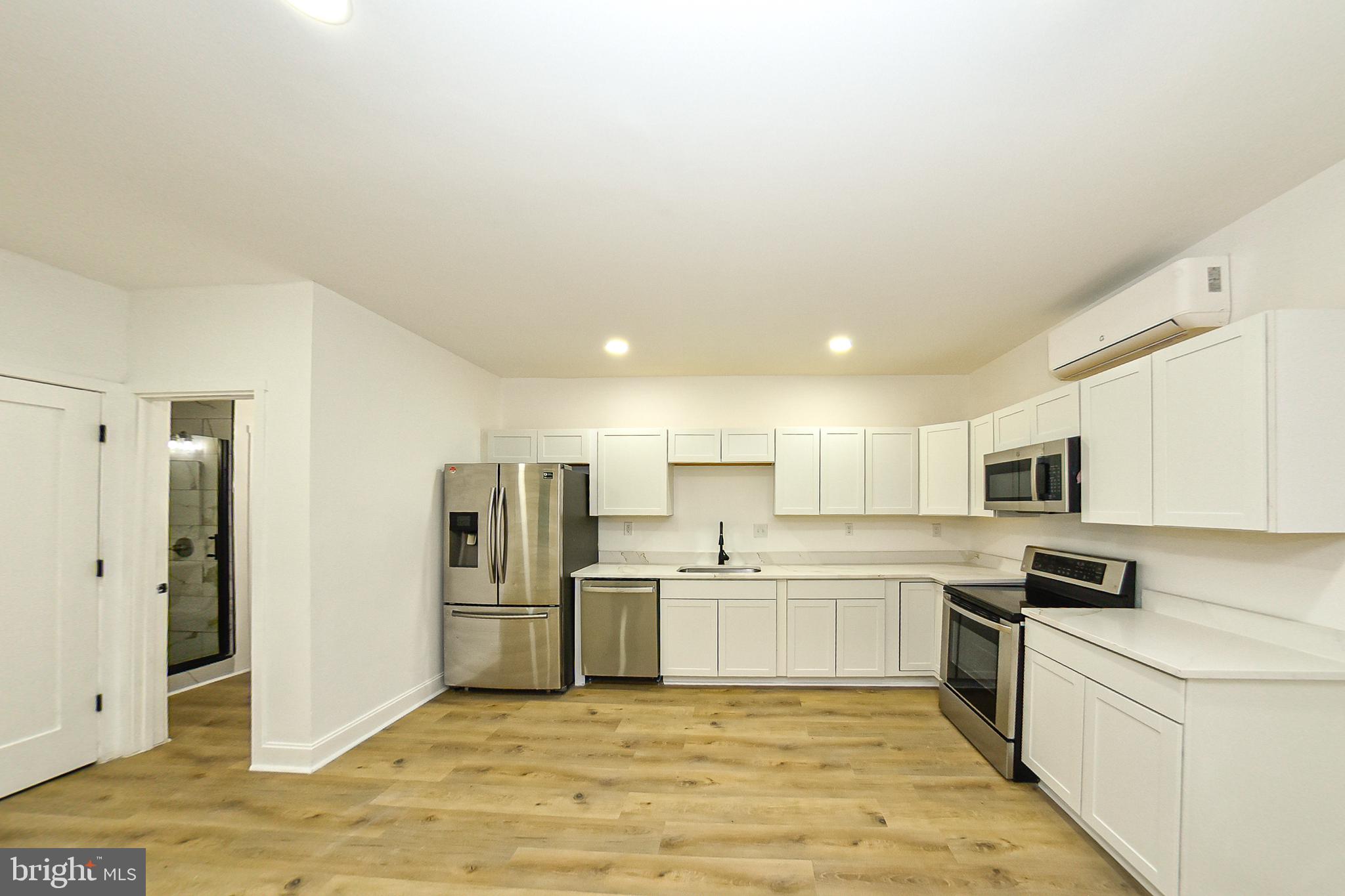 3704 Suitland Road Southeast Washington, DC 20020 - Photo 59 of 70 a large kitchen with cabinets and stainless steel appliances