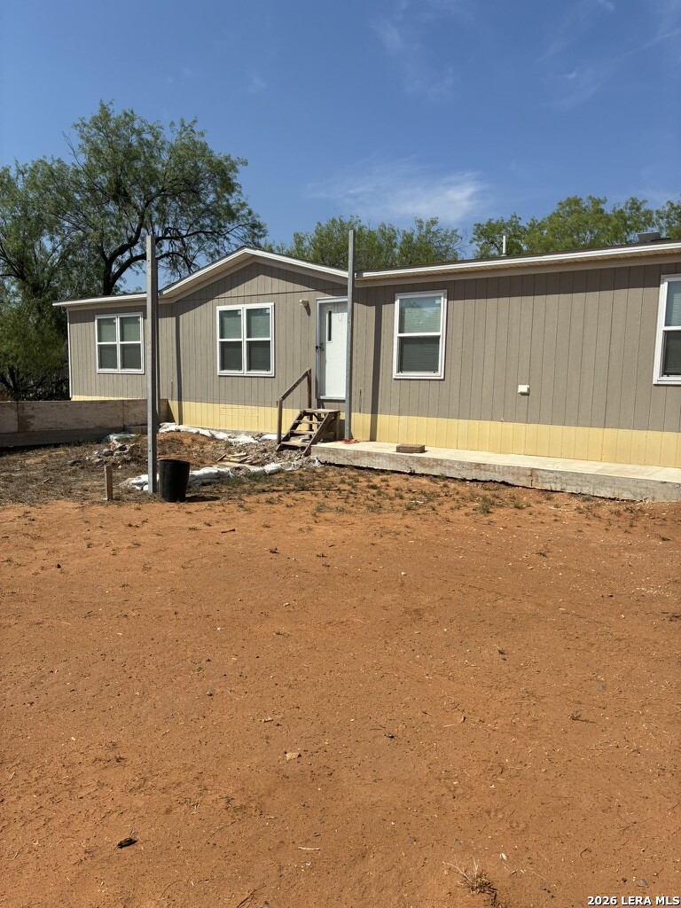 60 Childers Road Cotulla, TX 78014 - Photo 1 of 15 a front view of a house with a yard