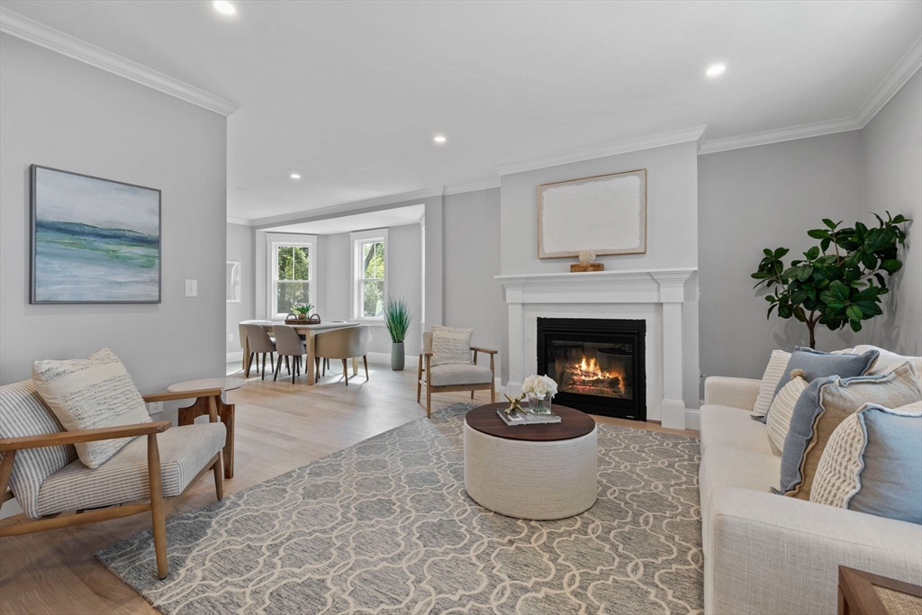 a living room with furniture a fireplace and a table