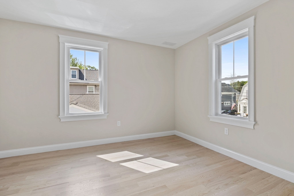 73 R Knoll Street, Unit 73R Boston, MA 02131 - Photo 4 of 11 an empty room with windows