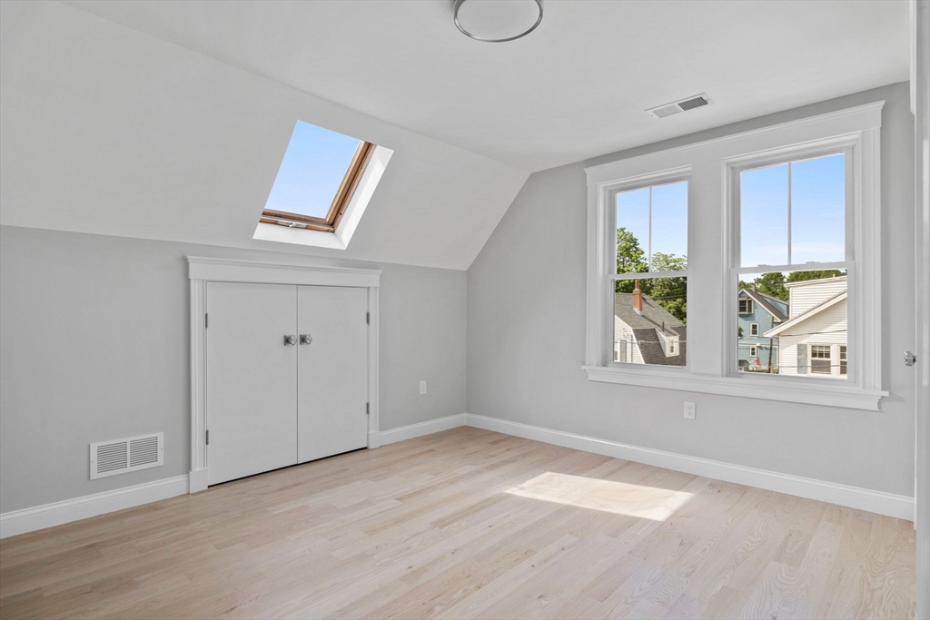 73 R Knoll Street, Unit 73R Boston, MA 02131 - Photo 5 of 11 an empty room with windows and closet