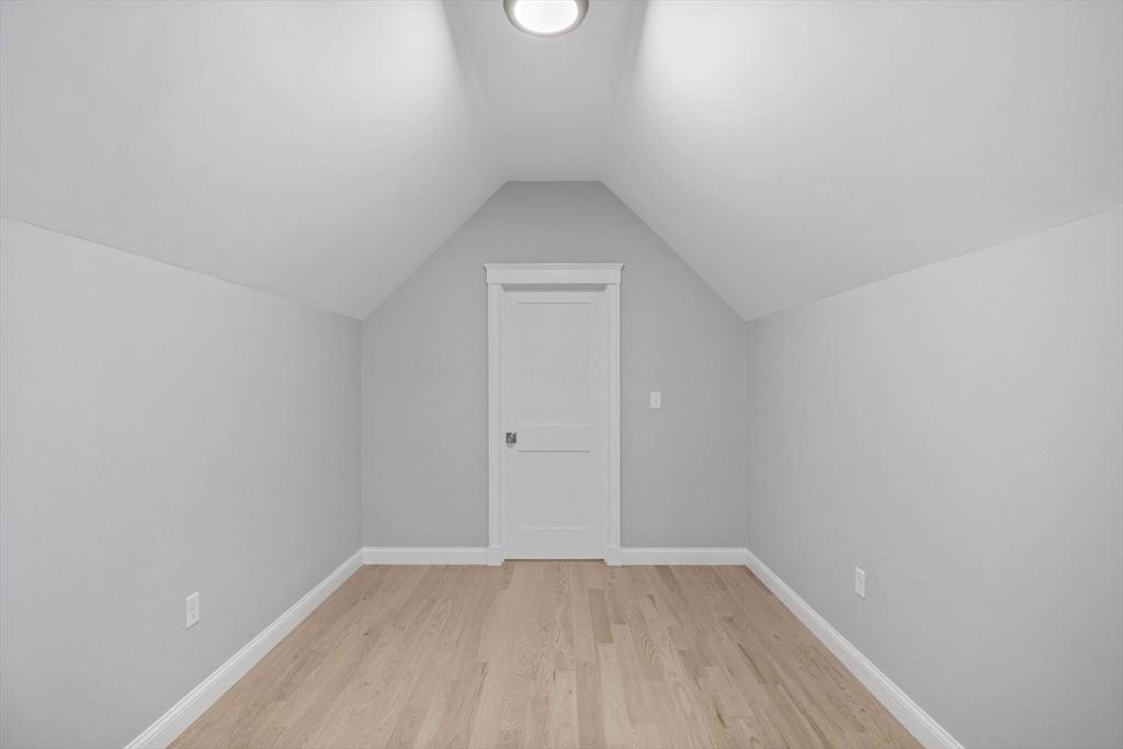 73 R Knoll Street, Unit 73R Boston, MA 02131 - Photo 6 of 11 a view of an empty room with wooden floor and a window