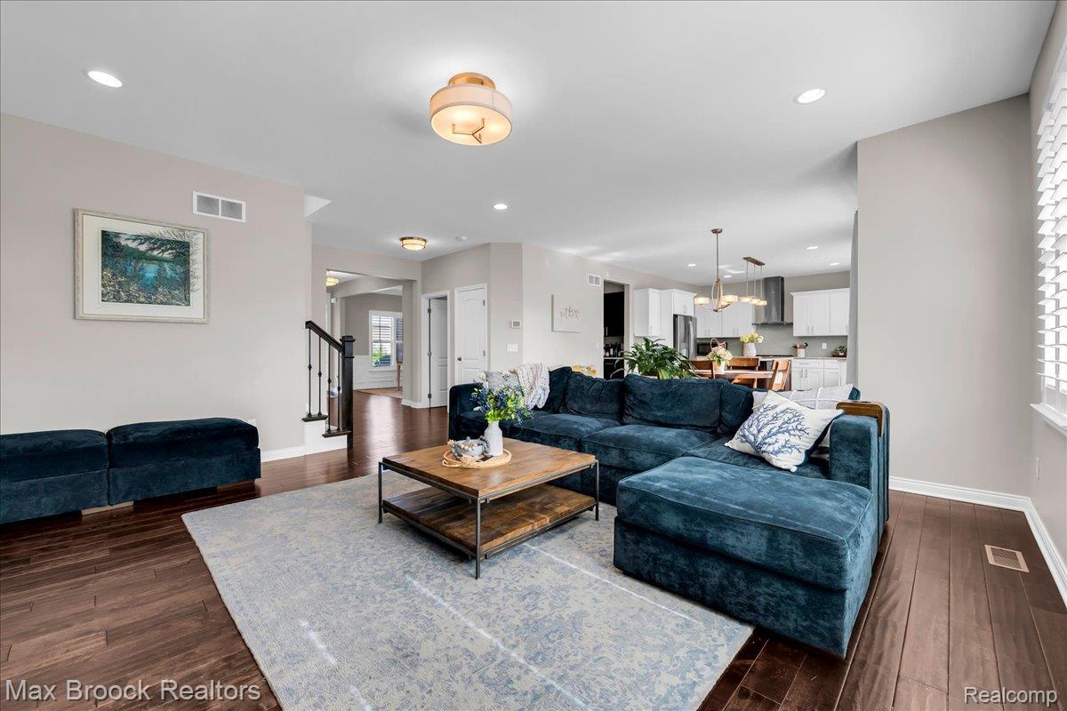 1126 Queensboro Drive Rochester, MI 48307 - Photo 14 of 66 Open-concept living space featuring wood-finish flooring, recessed lighting, and a modern ceiling fixture