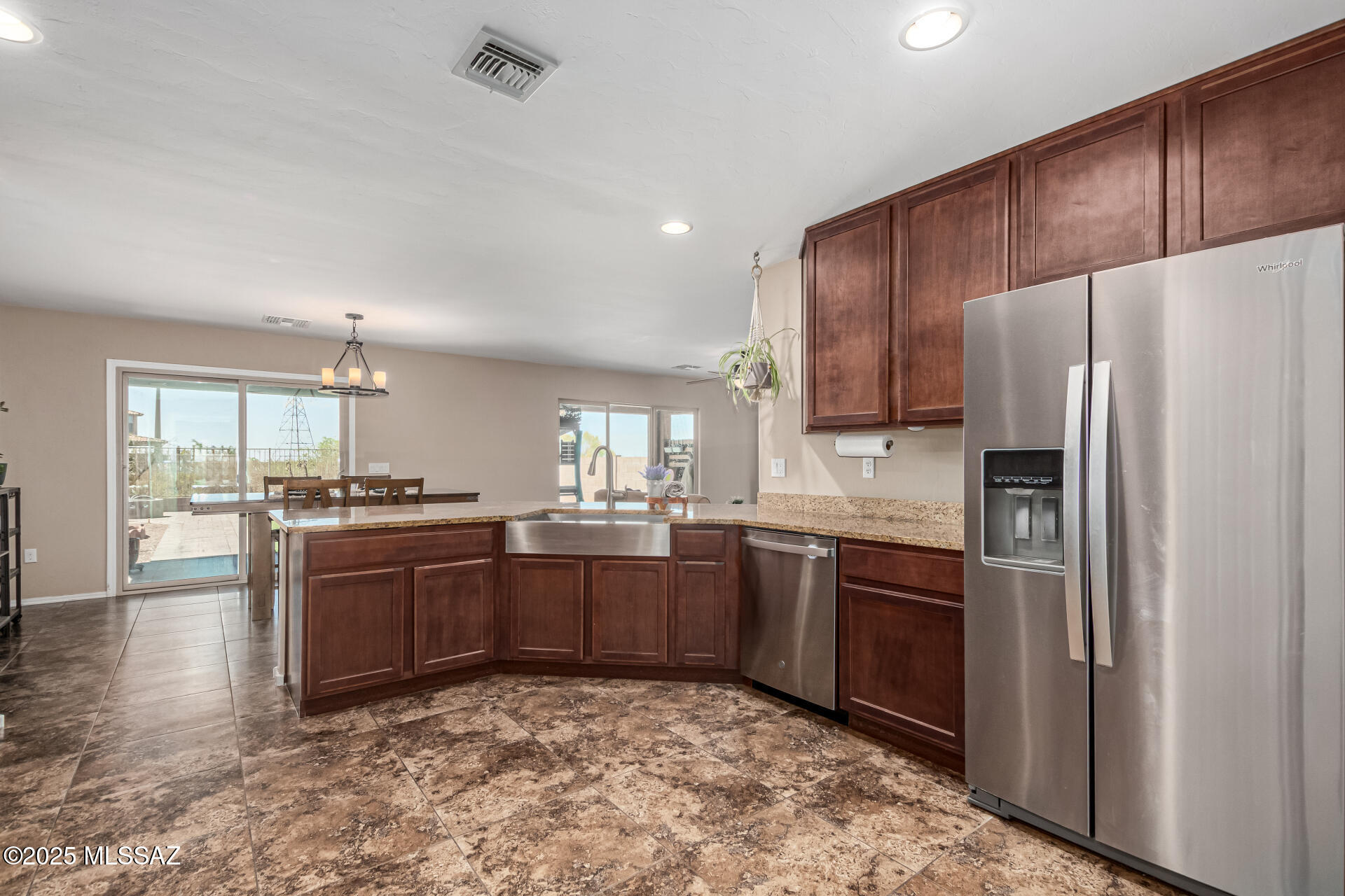 9528 Desert Fauna Loop Tucson, AZ 85747 - Photo 14 of 46 a kitchen with stainless steel appliances granite countertop a refrigerator and a stove top oven