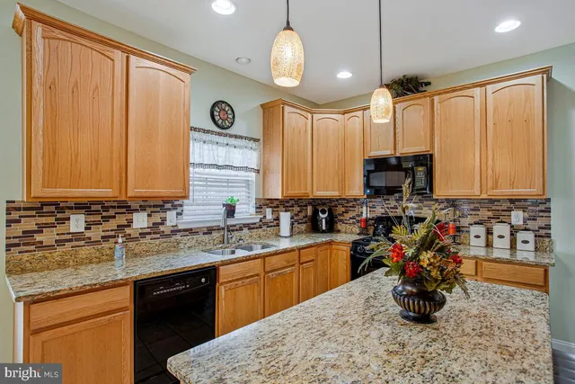 a kitchen with a sink a counter and cabinets