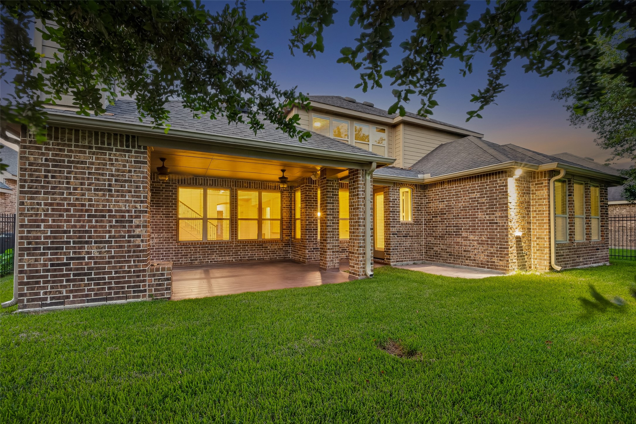 7930 Summer Night Lane Rosenberg, TX 77469 - Photo 44 of 48 Private backyard featuring an expansive covered patio and lush green lawn.