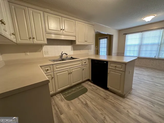 a kitchen with stainless steel appliances granite countertop a sink stove and cabinets
