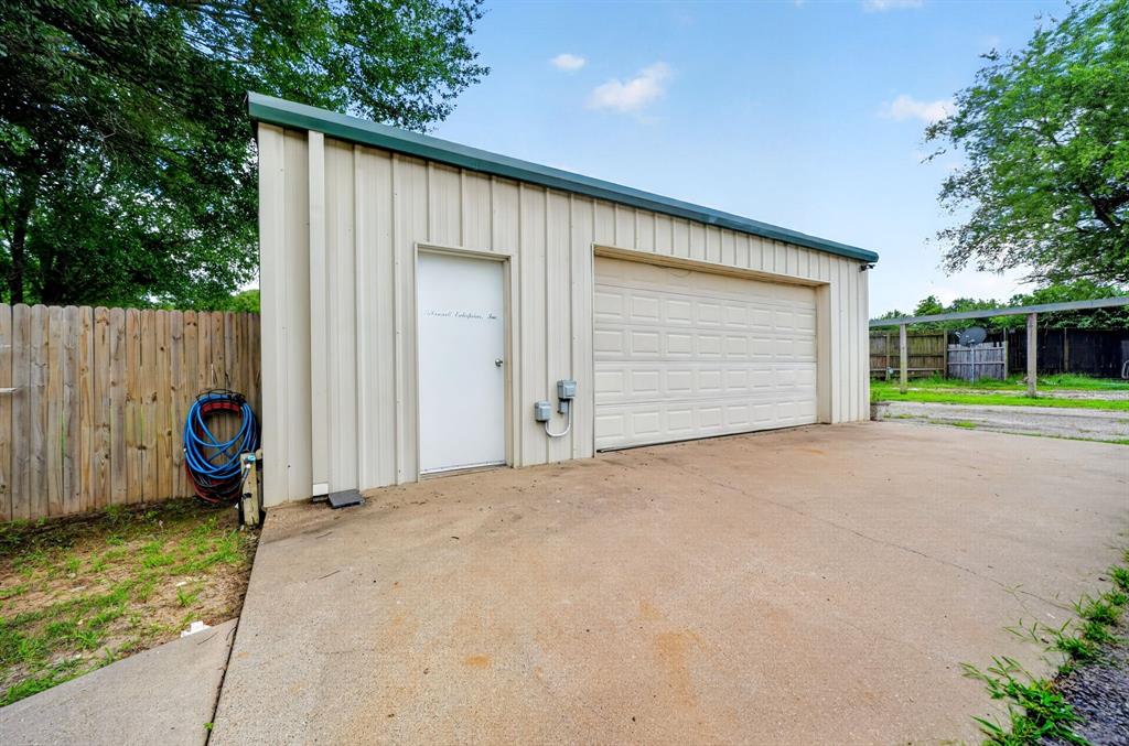 111 County Road 2806 Mabank, TX 75147 - Photo 24 of 34 Metal outbuilding featuring a single garage door and a separate entry door