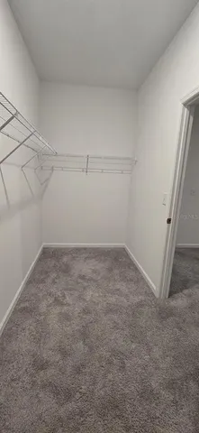a kitchen with granite countertop a sink stove and refrigerator