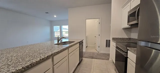 a room with a stove and a sink