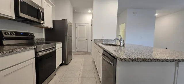 a view of kitchen with microwave and window