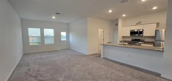 a kitchen with stainless steel appliances a refrigerator and microwave
