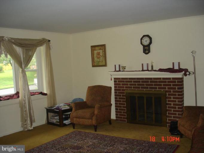 6714 Anders Terrace Springfield, VA 22151 - Photo 2 of 3 a living room with furniture and a fireplace