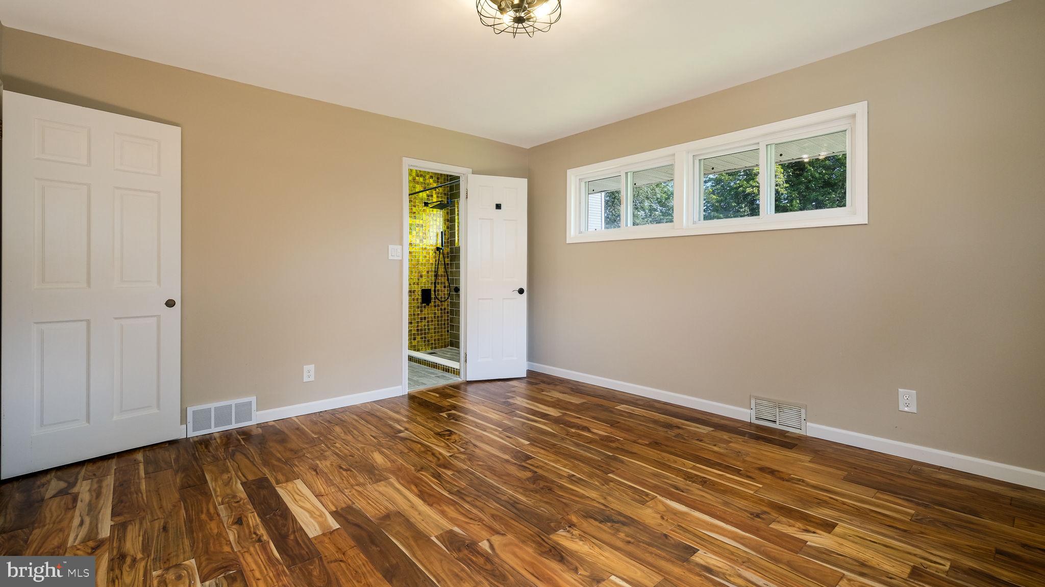1341 Carol Road Jenkintown, PA 19046 - Photo 16 of 56 a view of an empty room with wooden floor and a window