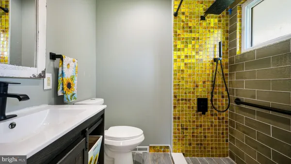 a bathroom with a sink a toilet and mirror