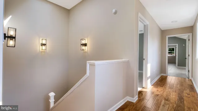 a view of hallway with wooden floor
