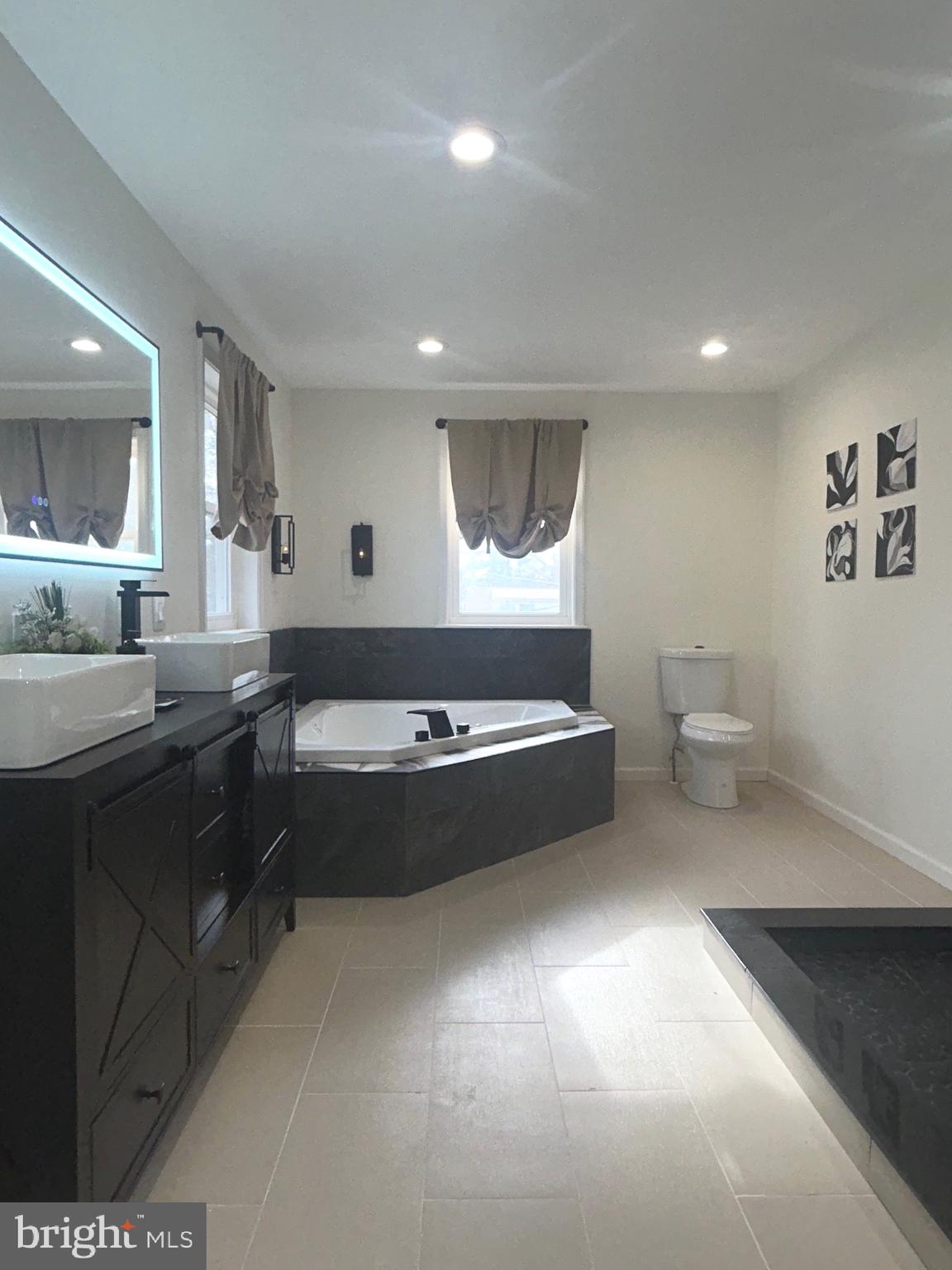 1341 Carol Road Jenkintown, PA 19046 - Photo 48 of 56 a spacious bathroom with a tub double vanity and a mirror