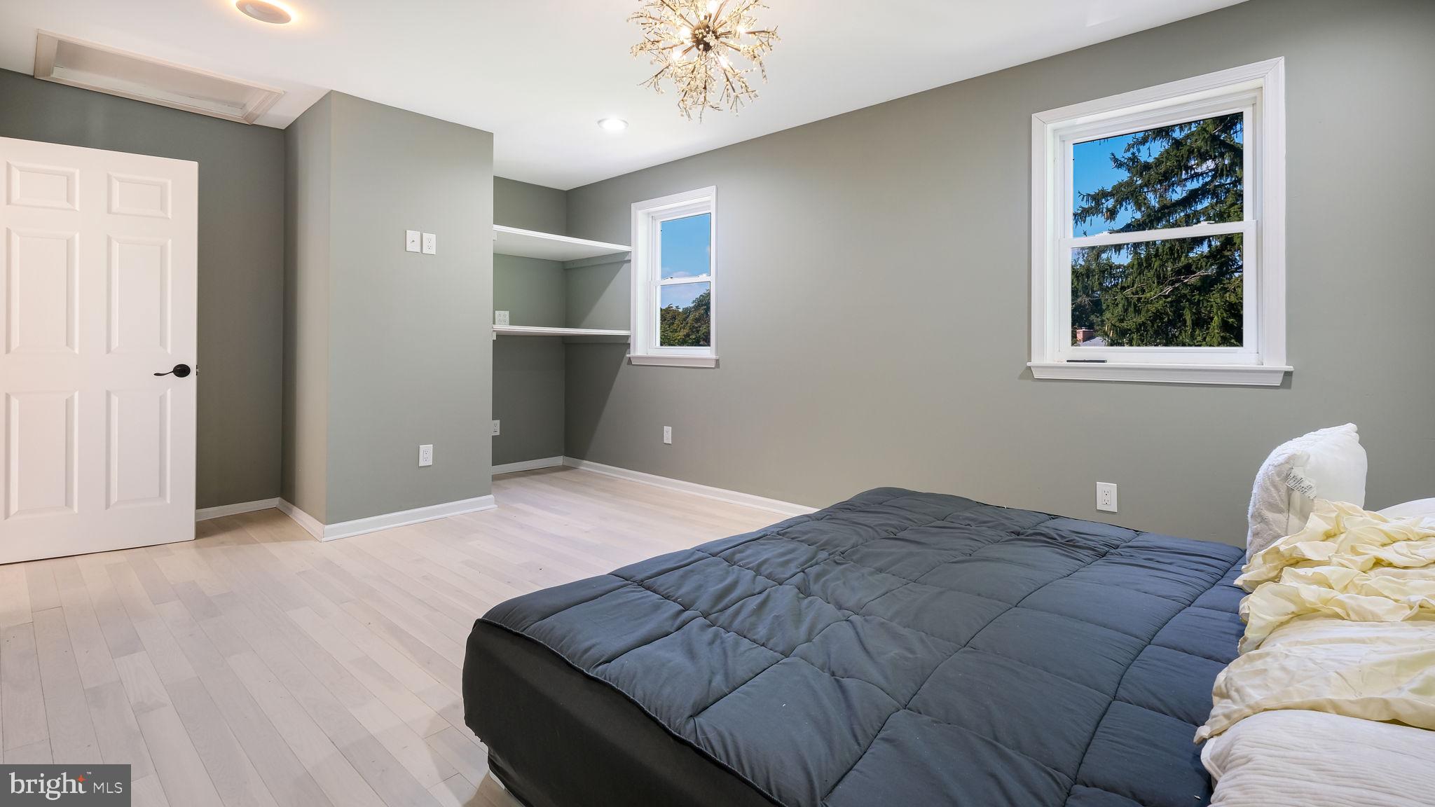 1341 Carol Road Jenkintown, PA 19046 - Photo 56 of 56 a bedroom with a bed and a chandelier