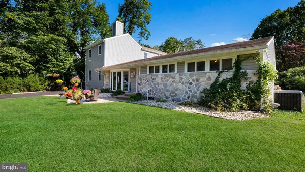 a view of a house with a backyard porch and sitting area