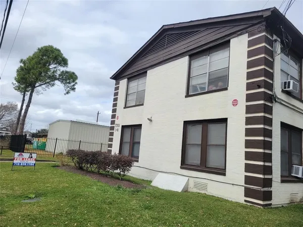 a house that has a big yard and large trees
