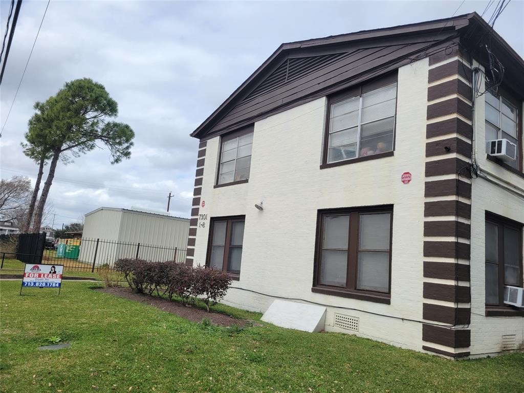 a house that has a big yard and large trees