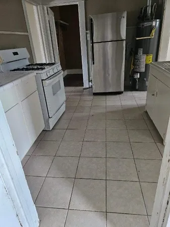 a view of a refrigerator in kitchen and an empty shelves