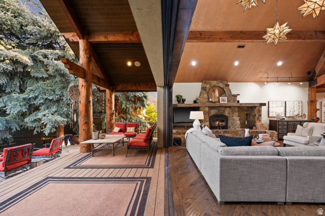 10280 Dimple Dell Road Sandy, UT 84092 - Photo 16 of 58 Outdoor / Indoor Living area with lofted ceiling, hardwood / wood-style floors, and a fireplace