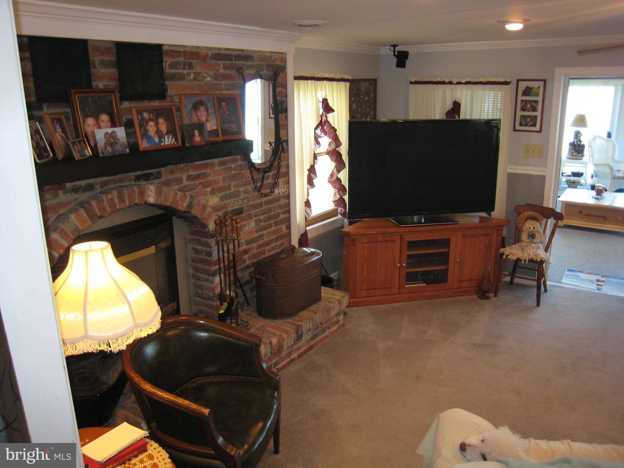6516 Blackhead Road Baltimore, MD 21220 - Photo 22 of 30 a living room with furniture and a flat screen tv