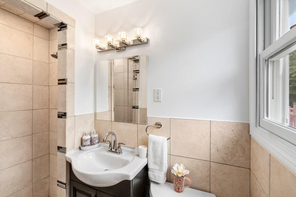 15 Pecunit Street Canton, MA 02021 - Photo 11 of 22 a bathroom with a sink shower and a mirror