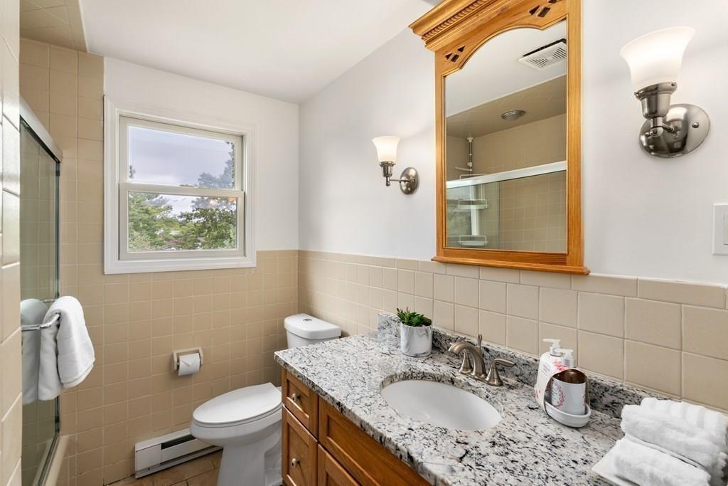 15 Pecunit Street Canton, MA 02021 - Photo 15 of 22 a bathroom with a granite countertop toilet sink and mirror